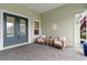 Inviting porch with seating area, decorative sand dollar, and neutral-colored walls at 716 Manns Harbor Dr, Apollo Beach, FL 33572