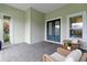 Inviting porch with seating area, decorative sand dollar, and neutral-colored walls at 716 Manns Harbor Dr, Apollo Beach, FL 33572