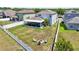 Expansive backyard with a screened-in patio and fire pit, captured from an aerial view at 7207 Forest Mere Dr, Riverview, FL 33578