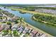 Stunning aerial view of a waterfront community showcasing the homes and surrounding waterways at 7207 Forest Mere Dr, Riverview, FL 33578