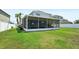 Large backyard with a screened-in patio, swing set, and spacious grassy area at 7207 Forest Mere Dr, Riverview, FL 33578