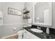 Cozy bathroom with granite counters, decorative shelves, and a toilet at 7207 Forest Mere Dr, Riverview, FL 33578