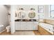 Stylish bathroom with dual sinks, round mirrors, modern lighting fixtures, and a soaking tub with tile surround at 7207 Forest Mere Dr, Riverview, FL 33578