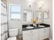 Bright bathroom with double vanity, granite countertop, and a separate toilet area at 7207 Forest Mere Dr, Riverview, FL 33578