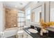 Well-lit bathroom with tile shower, tub, granite countertop and modern fixtures at 7207 Forest Mere Dr, Riverview, FL 33578