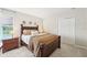 Cozy bedroom with a wood bed frame, dresser, closet, and a tranquil view at 7207 Forest Mere Dr, Riverview, FL 33578