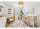 Comfortable Bedroom features a rocker, modern decor, neutral tones, and soft carpeting at 7207 Forest Mere Dr, Riverview, FL 33578