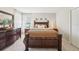 Inviting bedroom featuring dark wood furniture, soft lighting, and a peaceful ambiance at 7207 Forest Mere Dr, Riverview, FL 33578