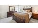 Comfortable bedroom with a dark wood bed frame, matching dresser, and ample natural light at 7207 Forest Mere Dr, Riverview, FL 33578