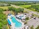 Elevated view of community pool with water slide, lounge chairs and shade canopies at 7207 Forest Mere Dr, Riverview, FL 33578