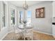Cozy dining area with a round table, white chairs, and a charming chandelier at 7207 Forest Mere Dr, Riverview, FL 33578