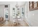 Bright dining nook with a round table, white chairs, and plenty of natural light from the surrounding windows at 7207 Forest Mere Dr, Riverview, FL 33578