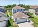 Beautiful two-story home featuring a well-manicured lawn and a view of the water at 7207 Forest Mere Dr, Riverview, FL 33578