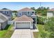 Charming two-story home featuring a two-car garage, neutral paint, and well-manicured lawn at 7207 Forest Mere Dr, Riverview, FL 33578