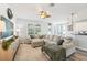 Comfortable living room features a large sectional sofa, ceiling fan, and modern decor at 7207 Forest Mere Dr, Riverview, FL 33578