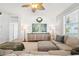Cozy living room with a sectional sofa, decorative features, and modern lighting at 7207 Forest Mere Dr, Riverview, FL 33578