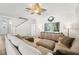 Bright living room with a large sectional sofa, decorative accents, and wood-look floors at 7207 Forest Mere Dr, Riverview, FL 33578