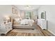 Spacious bedroom with light wood flooring, neutral tones, ceiling fan and large windows at 7207 Forest Mere Dr, Riverview, FL 33578