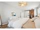 Bright bedroom with ceiling fan, en suite bathroom, wooden floors, and sliding barn door at 7207 Forest Mere Dr, Riverview, FL 33578