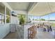 Relaxing screened-in patio with a brick bar, TV, and seating area overlooking the backyard at 7207 Forest Mere Dr, Riverview, FL 33578