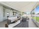Enjoyable screened-in patio with a full bar, cozy seating, and a view of the backyard at 7207 Forest Mere Dr, Riverview, FL 33578