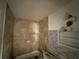 Bathroom features a tiled shower, vanity, and lighting at 7365 Royal Palm Dr, New Port Richey, FL 34652