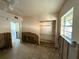 Unfinished living room with visible wall studs, ceiling fan, and window at 7365 Royal Palm Dr, New Port Richey, FL 34652