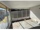 Screened sunroom with gray concrete floor and partial black coverings on screen at 7365 Royal Palm Dr, New Port Richey, FL 34652