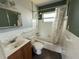 Bathroom needing repair with a sink, toilet, tub and shower head at 7366 Royal Palm Dr, New Port Richey, FL 34652
