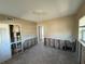 Living room needing repair with outdated walls, visible wall studs, and view of front door at 7366 Royal Palm Dr, New Port Richey, FL 34652