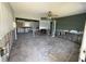 View of gutted living room and kitchen area, with natural light streaming in through the windows at 7366 Royal Palm Dr, New Port Richey, FL 34652