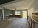 View of gutted living room and kitchen area, with natural light streaming in through the windows at 7366 Royal Palm Dr, New Port Richey, FL 34652