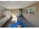 Screened patio needing repair and featuring a wall air conditioning unit at 7366 Royal Palm Dr, New Port Richey, FL 34652