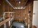 Utility room needing repair with a water heater and wooden walls at 7366 Royal Palm Dr, New Port Richey, FL 34652