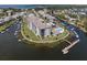 An aerial view of condo complex with water access, community pool, and docks at 8141 Aquila St # 342, Port Richey, FL 34668