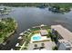 Aerial view of condo complex with waterfront access, community pool, docks and water views at 8141 Aquila St # 342, Port Richey, FL 34668