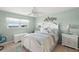 Serene bedroom with neutral tones, ceiling fan, and a bright window overlooking the beach at 8141 Aquila St # 342, Port Richey, FL 34668