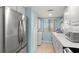 Bright kitchen features stainless steel appliances, white cabinets, and in-unit washer/dryer at 8141 Aquila St # 342, Port Richey, FL 34668