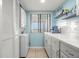 Cozy kitchen features in-unit washer/dryer, white cabinetry, and bright window view at 8141 Aquila St # 342, Port Richey, FL 34668