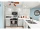 Bright kitchen with stainless appliances, white cabinetry, marble counters, and stainless sink at 8141 Aquila St # 342, Port Richey, FL 34668