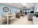 Open-concept living and dining area with comfortable seating, ceiling fan and balcony access at 8141 Aquila St # 342, Port Richey, FL 34668