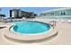 Enjoy the beautiful community pool and surrounding white lounge chairs with buildings in the background on a clear day at 8141 Aquila St # 342, Port Richey, FL 34668