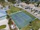 Aerial view of community tennis courts, putting green, and well-maintained landscaping at 8141 Aquila St # 342, Port Richey, FL 34668