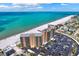 Stunning aerial view of oceanfront condo, beach, and parking with bright blue ocean backdrop at 880 Mandalay Ave # N710, Clearwater Beach, FL 33767
