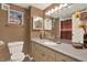 Cozy bathroom with vanity, mirror, and beige accent wall at 880 Mandalay Ave # N710, Clearwater Beach, FL 33767