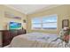 Inviting bedroom featuring a large window with stunning sky views and tile flooring at 880 Mandalay Ave # N710, Clearwater Beach, FL 33767