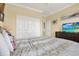 Comfortable bedroom with tile flooring, closet, and bright lighting at 880 Mandalay Ave # N710, Clearwater Beach, FL 33767