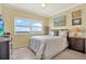 Cozy bedroom featuring natural light, neutral tones, and tile flooring at 880 Mandalay Ave # N710, Clearwater Beach, FL 33767