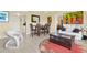 Open-concept living space with dining area, neutral decor, and lots of natural light at 880 Mandalay Ave # N710, Clearwater Beach, FL 33767