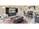 Cozy living room featuring entertainment center, tile flooring, and modern furnishings at 880 Mandalay Ave # N710, Clearwater Beach, FL 33767